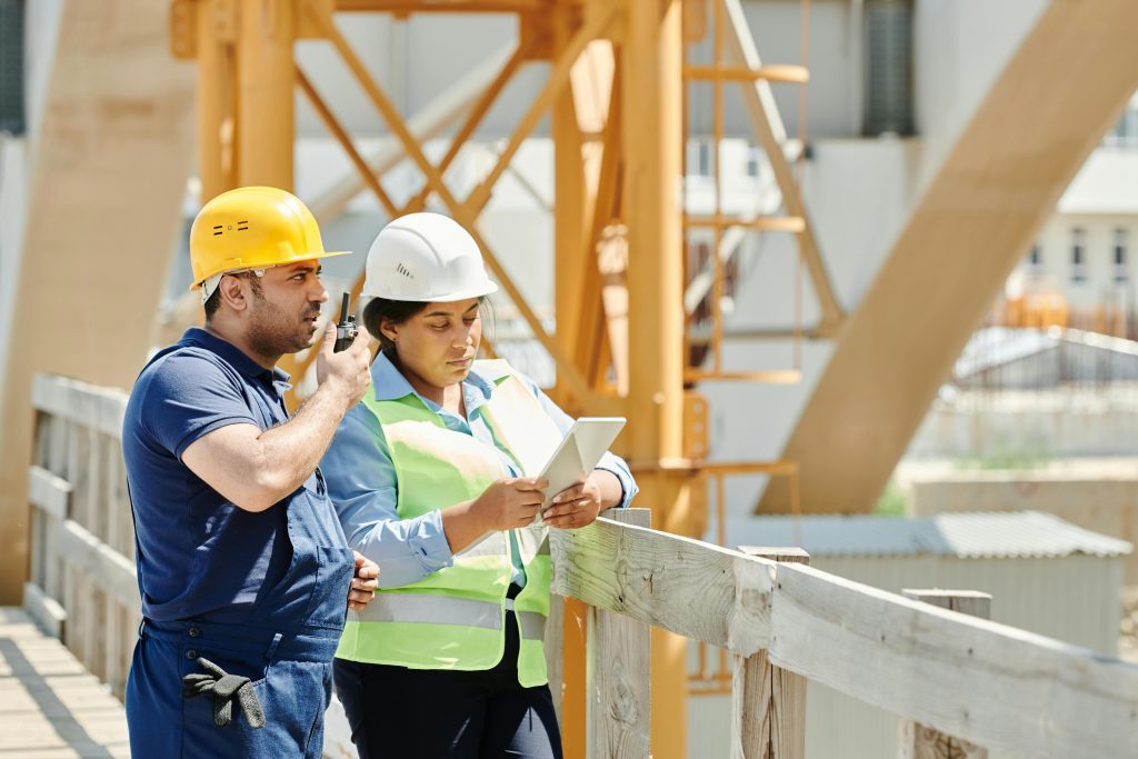 International Women's Day 2025: A man and a woman on a construction site wearing protective gears