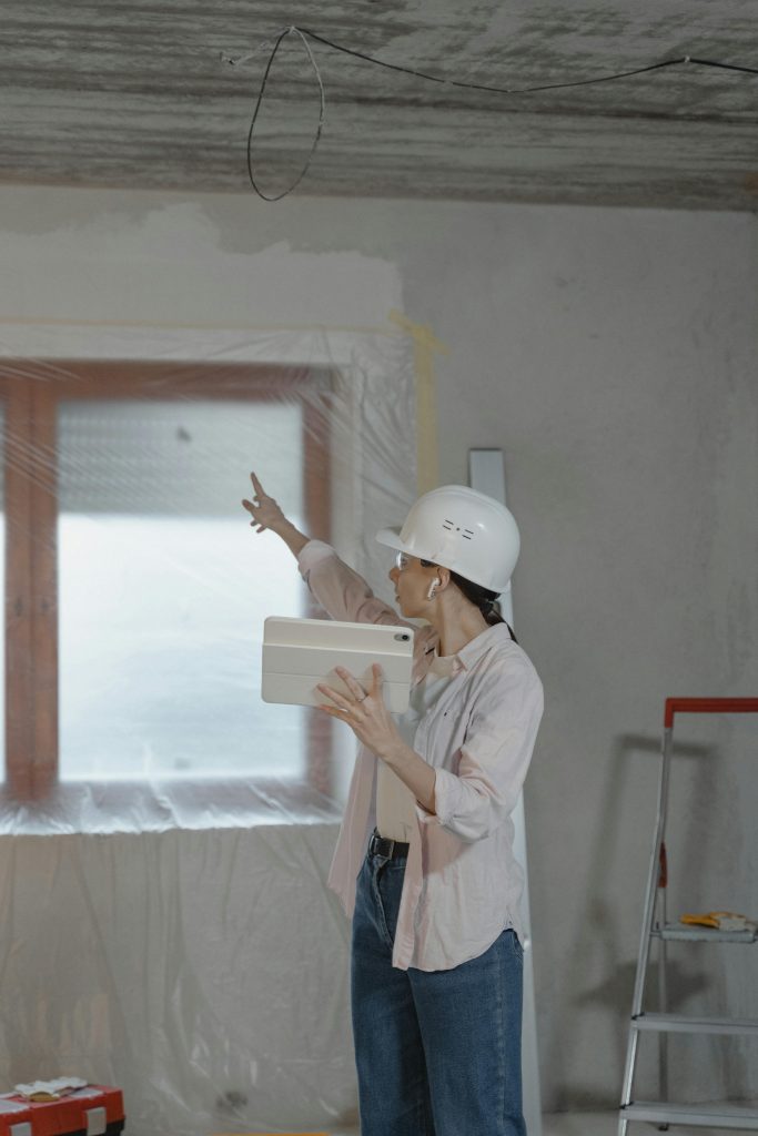 IWD 2025: A female construction doing inspection wearing a white protective gear