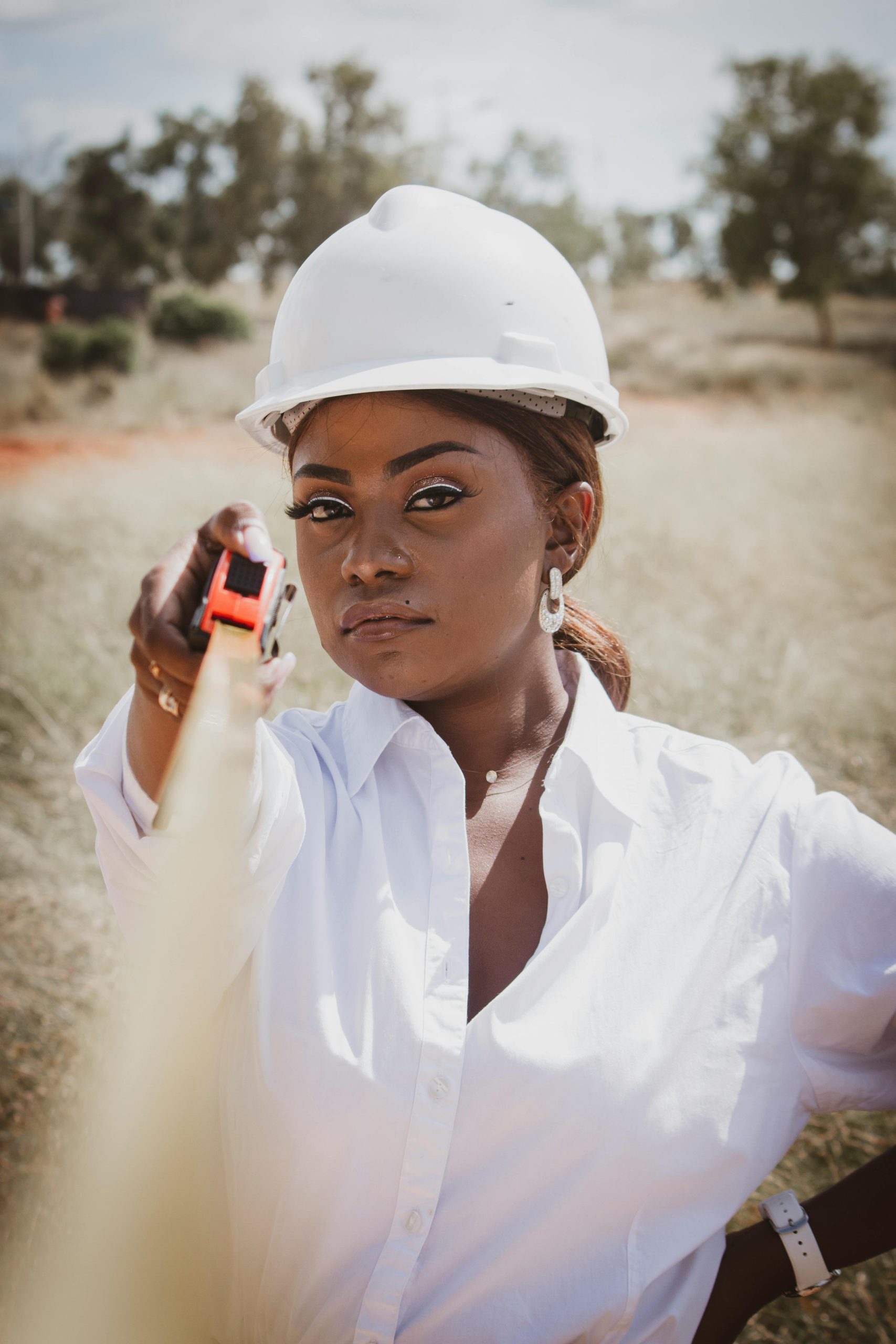 A woman where PPE and an industrial tape rule