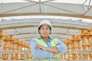 Female construction worker wearing a hard hat on site