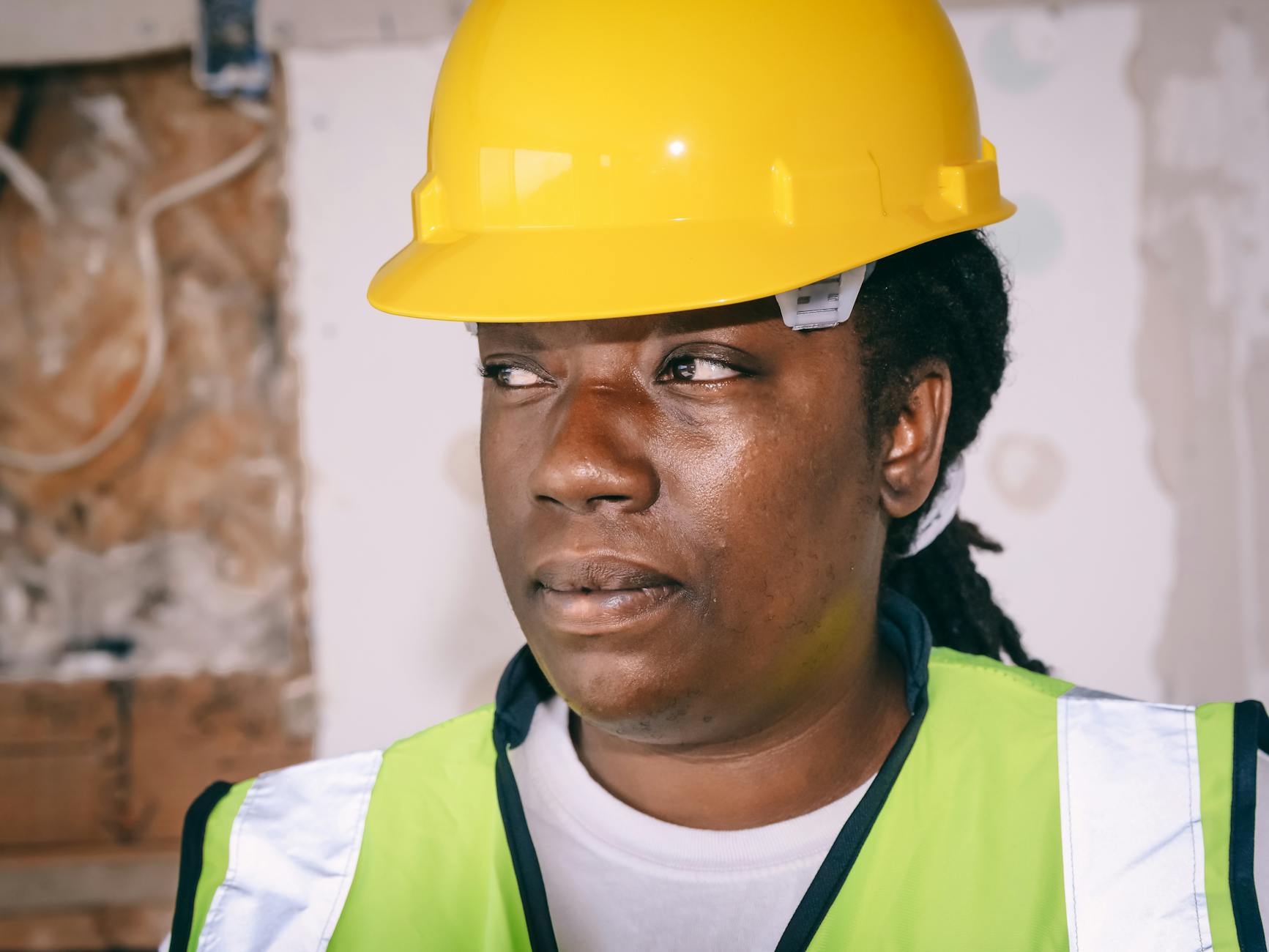 A woman working on a construction site in full PPE