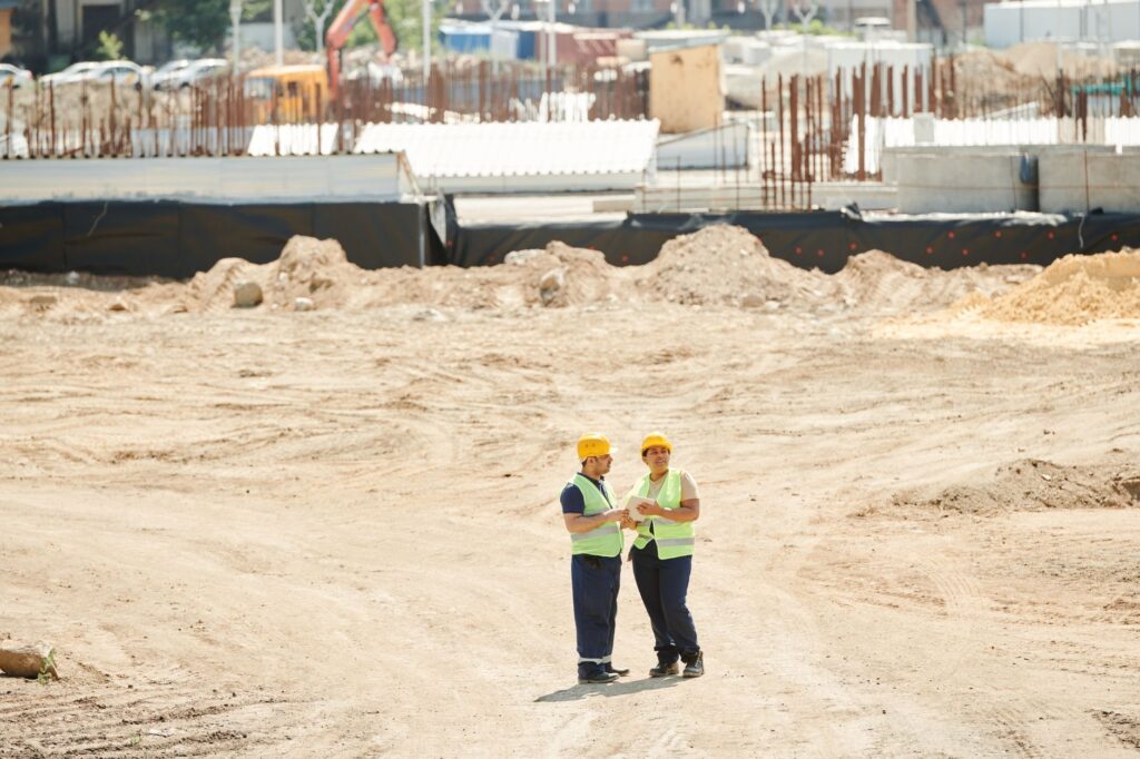 A newly promoted construction supervisor reviewing drawings on site