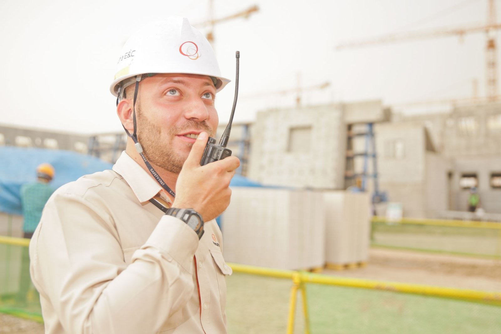 A construction supervisor listening carefully to a worker on site