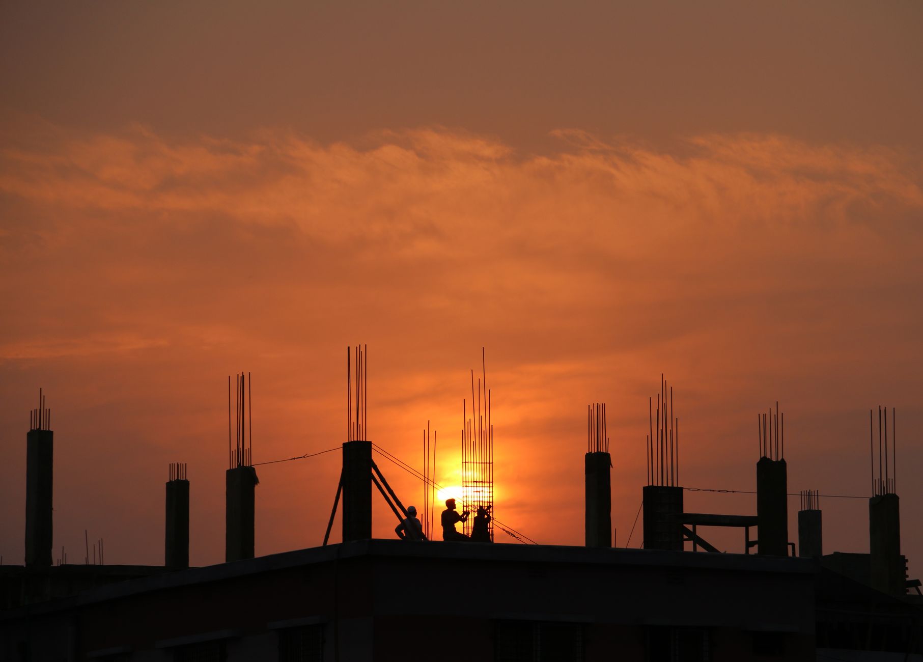 A construction crew continuing work late in the day