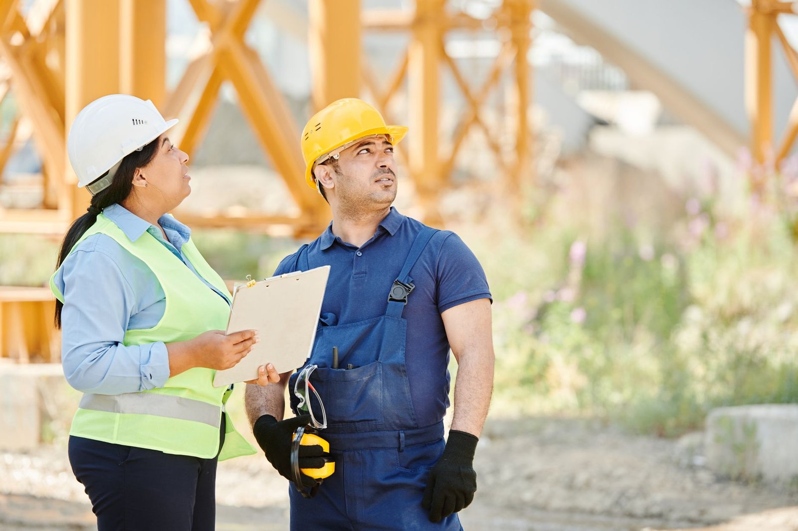 A construction supervisor holding a private conversation with a worker