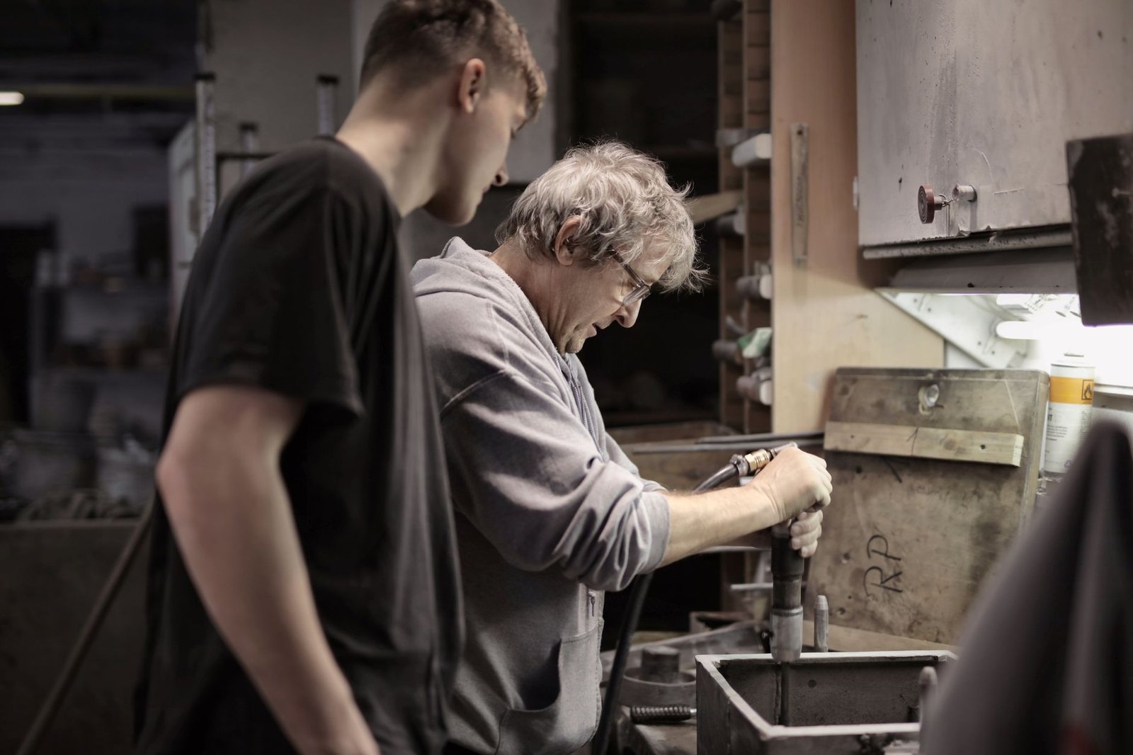 An experienced tradesperson working alongside an apprentice