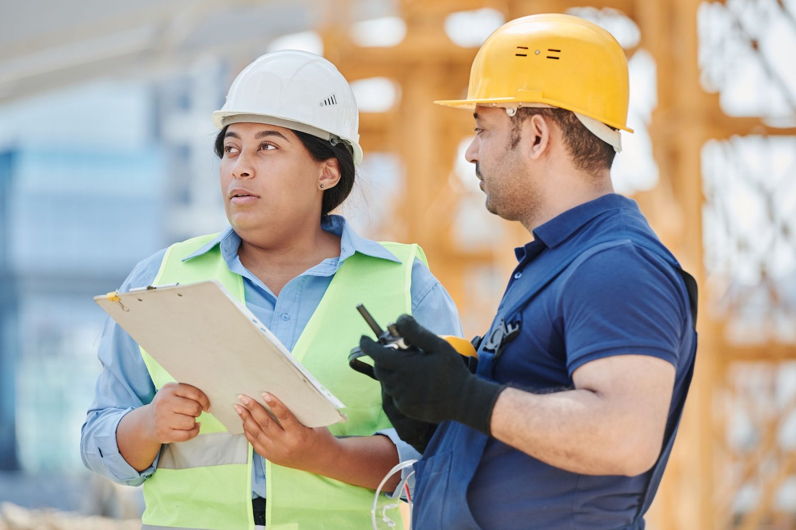 Two construction workers in a tense discussion on a work front