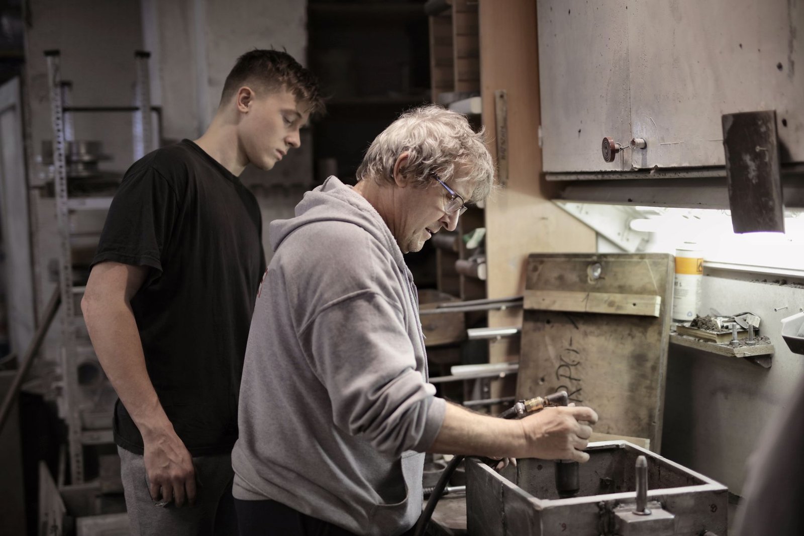 An apprentice being mentored on a construction work front